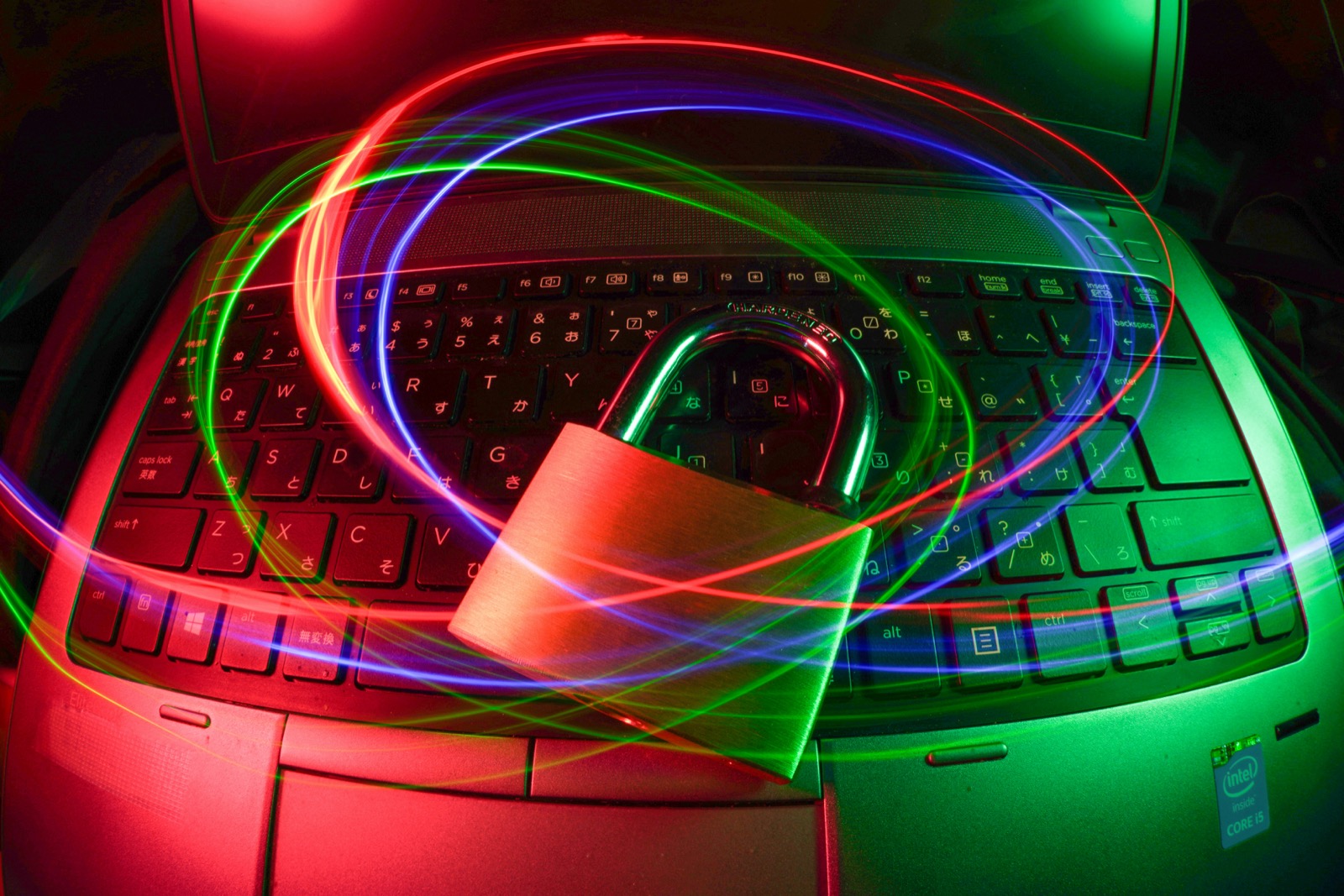 Keyboard secured by a padlock with red and green light trails