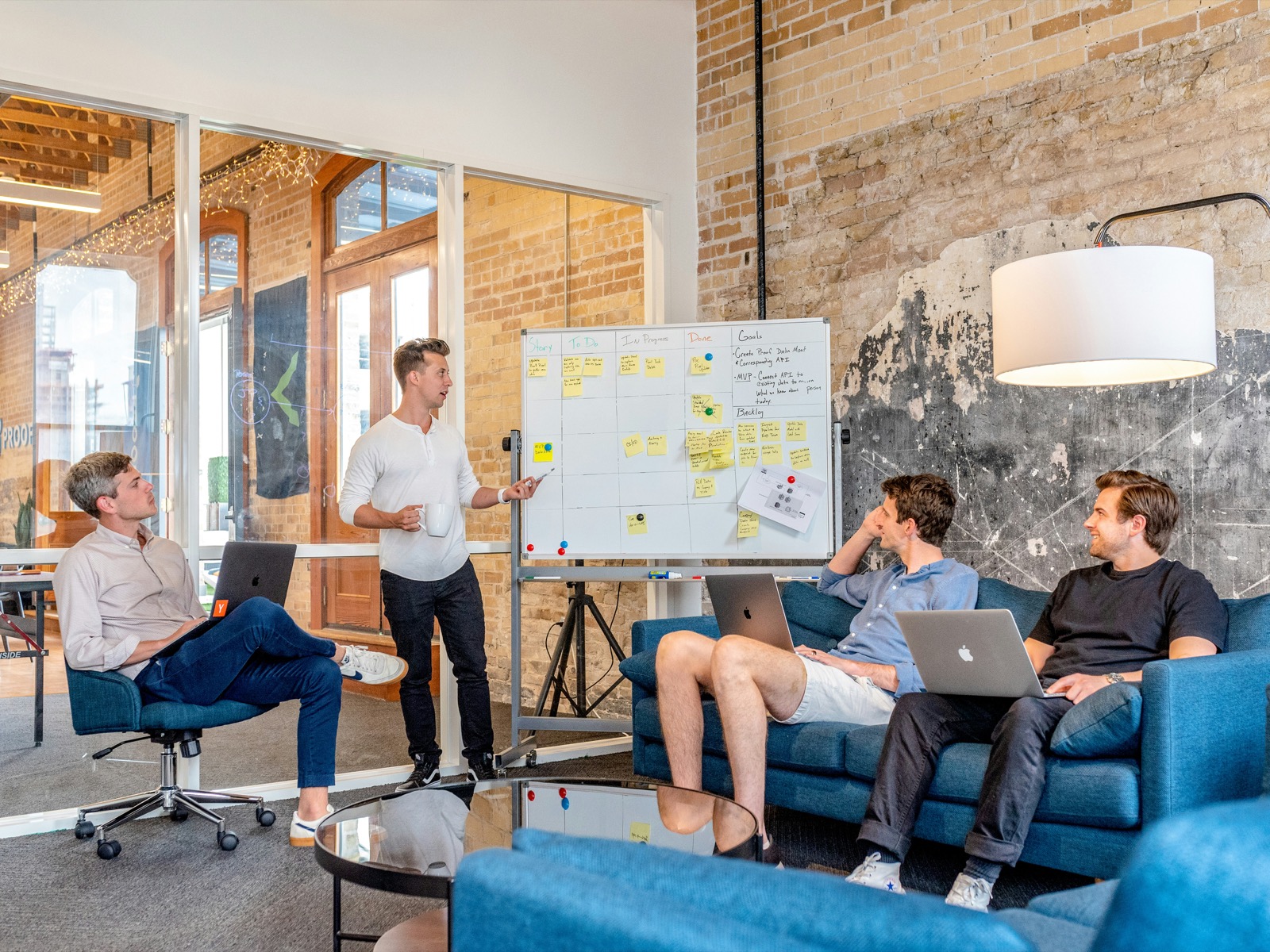 Engineers collaborating around a whiteboard in a modern office