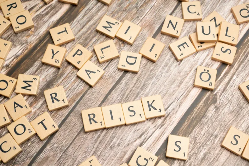Risk and compliance letters on wooden tiles